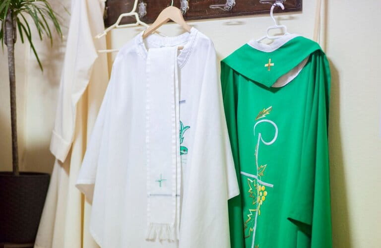 Liturgical clothes and priest's vestments hang on the clothes wall Liturgical clothes and priest's vestments hang on the clothes wall