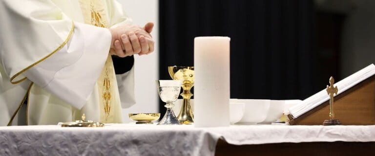 Clipping image of A priest at the change reading a passage from the Bible. Clipping image of A priest at the change reading a passage from the Bible.