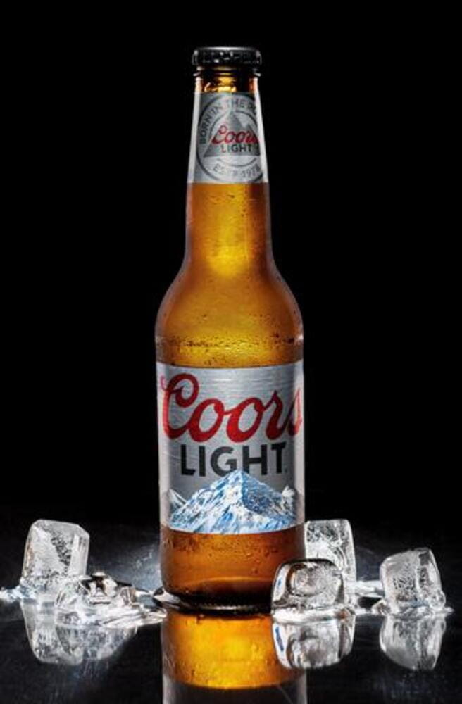 Bottle of cold Coors Light beer on a black background. Bottle of cold Coors Light beer on a black background.