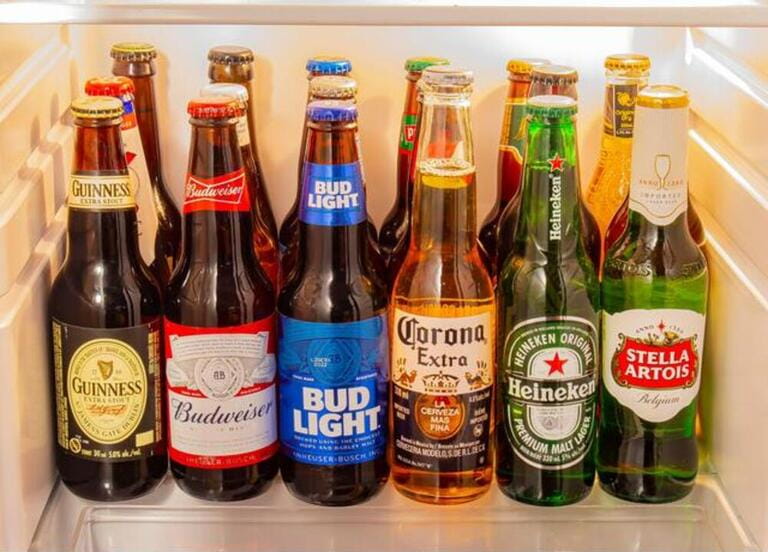 A group of world popular beer brands inside of a fridge A group of world popular beer brands inside of a fridge