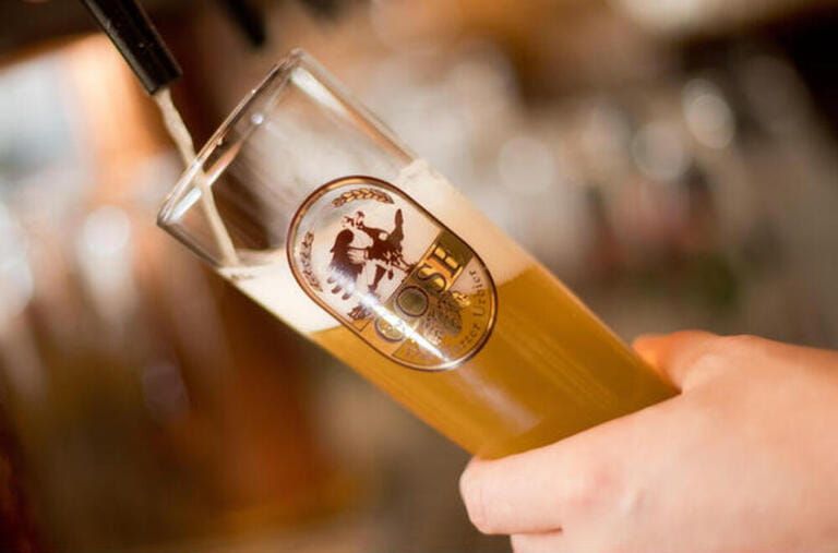 A glass of Gose beer, an old recipe containing salt and coriander, in the Goslar brewery in the Harz, Germany A glass of Gose beer, an old recipe containing salt and coriander, in the Goslar brewery in the Harz, Germany