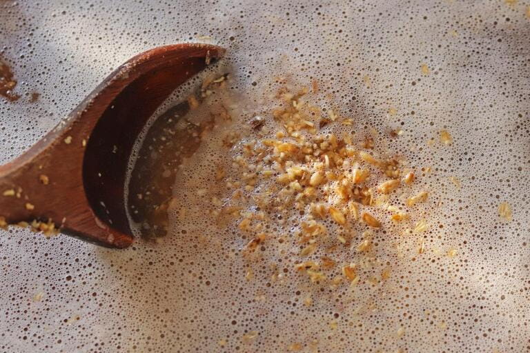 Homebrew: beer wort with wood spoon Homebrew: beer wort with wood spoon