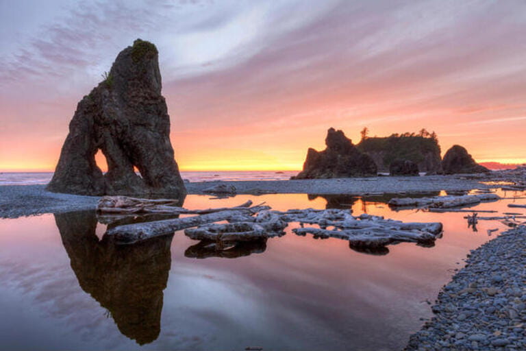 Sunset reflected in a slow moving stream, with sea stacks and driftwood, at Ruby Beach in Olympic National Park, Washington. Sunset reflected in a slow moving stream, with sea stacks and driftwood, at Ruby Beach in Olympic National Park, Washington.
