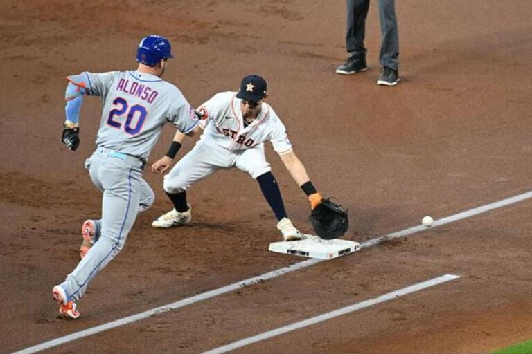New York Mets first baseman PETE ALONSO (20) is out at first for running inside the baseline and interfering with the throw as Houston Astros first ba