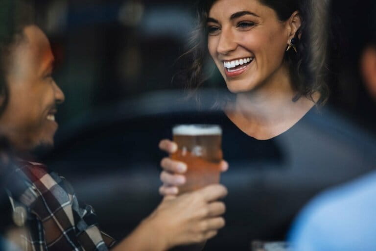 Waitress serving beer to man in bar Waitress serving beer to man in bar