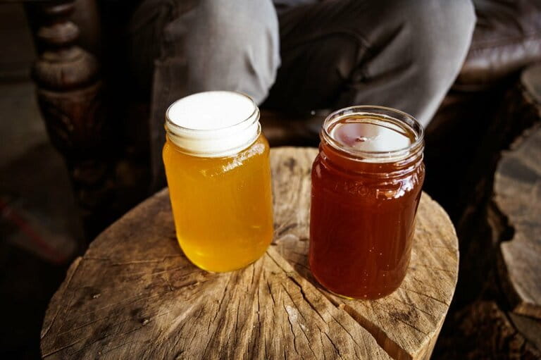 An IPA and a red ale on a wooden stump An IPA and a red ale on a wooden stump