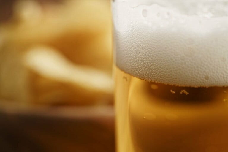Close-up of a glass of lager beer on a wooden table Close-up of a glass of lager beer on a wooden table