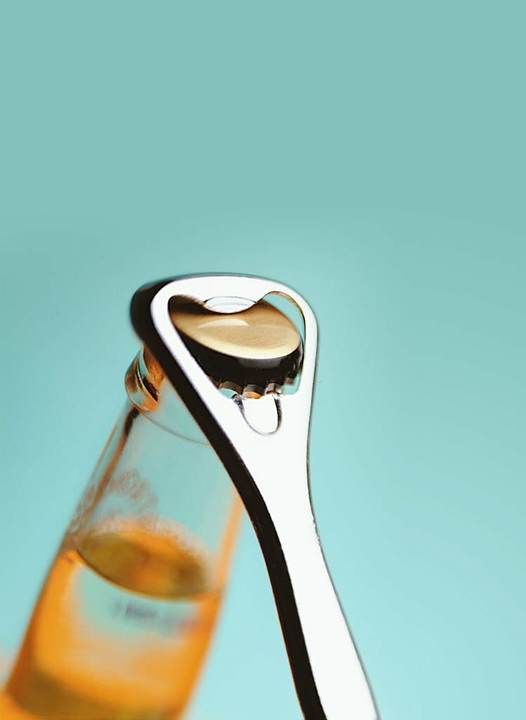 Bottle opener opening bottle of soda Bottle opener opening bottle of soda