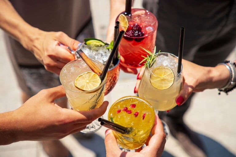Five cocktails in hand participate in the celebratory toast Five cocktails in hand participate in the celebratory toast