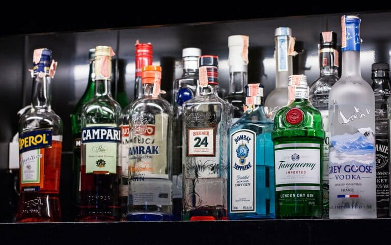 A variety of alcoholic drinks, Bernd, are placed on shelves in the bar for cocktail enjoyment. A variety of alcoholic drinks, Bernd, are placed on shelves in the bar for cocktail enjoyment.